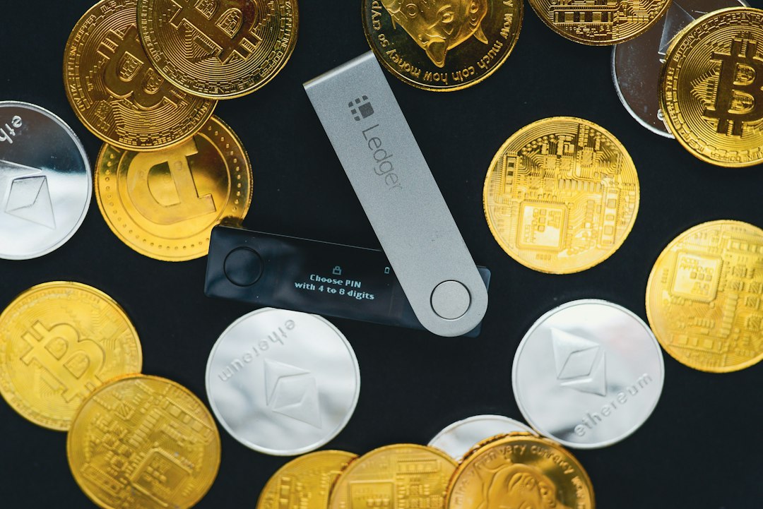 Bitcoin hardware wallet and coin on desk