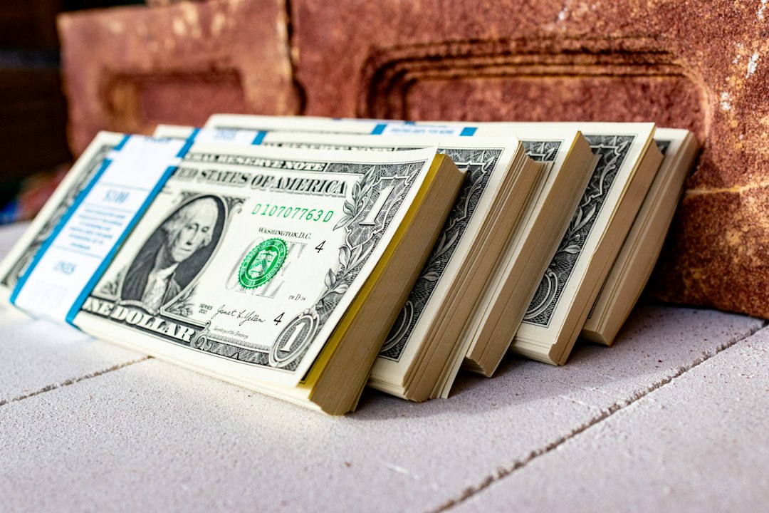 US dollar bills beside an oil barrel model