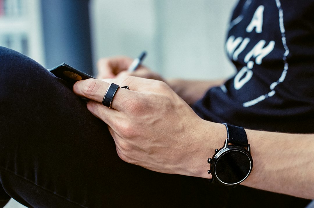 Oura-style smart ring beside a smartphone