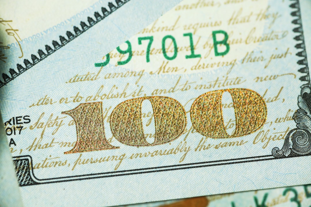 US dollar bills beside government bond documents